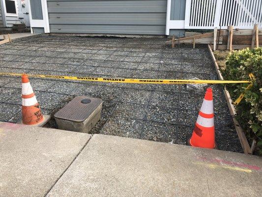 Excavated driveway with rebar in place, suspended on "dobie" blocks to enable concrete to surround the rebar.