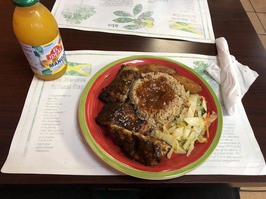 Jerk Chicken, beans and rice, cabbage, and plantains.