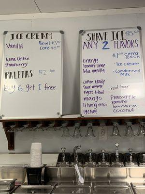 Signs for ice cream with charming ice cream dishes hanging below, like an old-fashioned soda fountain.