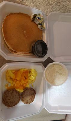 Pancake plate with scrambled cheese eggs, turkey sausage, and grits