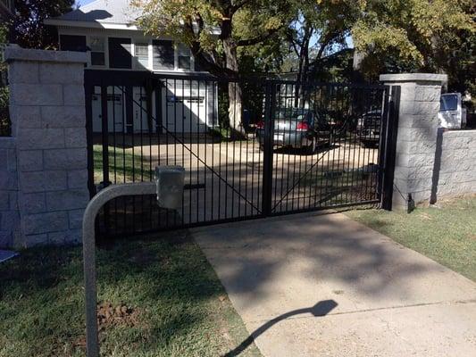 Custom Iron Gates with two electric gate operators and wireless numeric keypad.