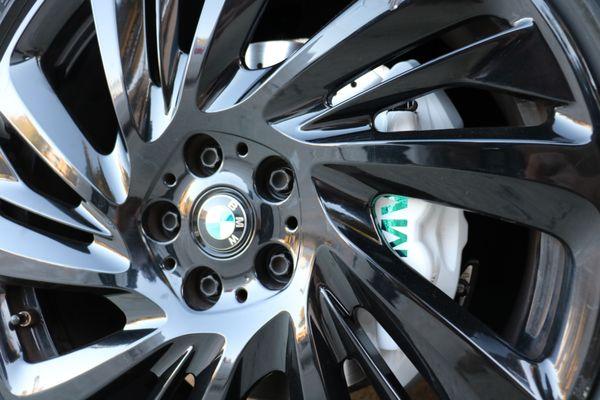 Wrapped calipers white with custom cut out BMW on top to match the chrome color of the car