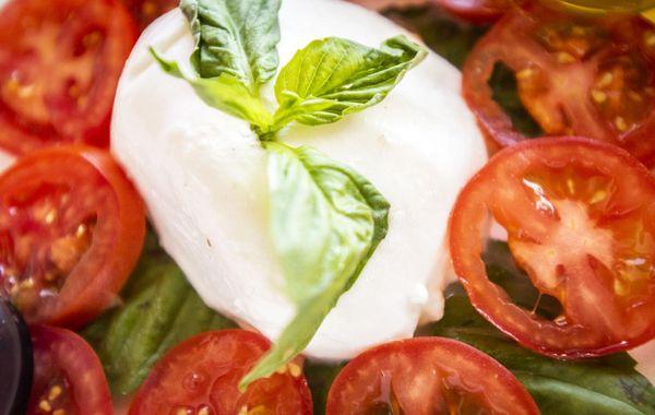 Caprese Salad with Imported Bufala Mozerella Cheese , Fresh tomatoes and basil.