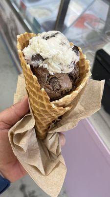 Vanilla and chocolate moose tracks ice cream on a hot fresh waffle cone