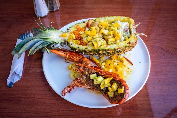 Deep Fried Lobster with Pineapple boat of Mashed Potatoes, Fiesta Rice and Garlic buttered scallop topped with out home made Mango pineapple