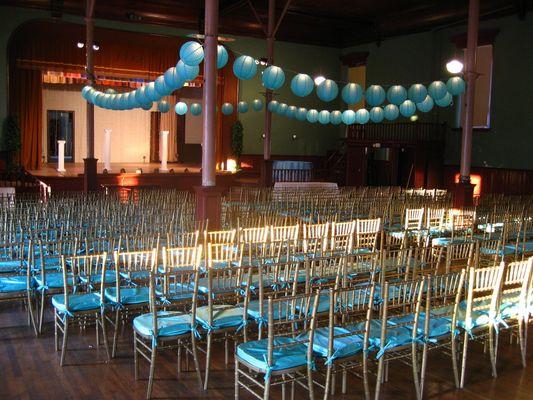 Silver Chiavari Chair rentals at a wedding with light blue seat cushions.