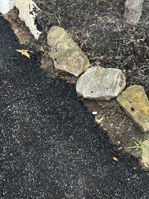 Put asphalt around the rocks instead of moving them so it would be even