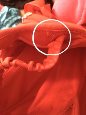 The elastic straps that were sewn to the actual off shoulder straps were no longer attached, thread was just hanging on both sides