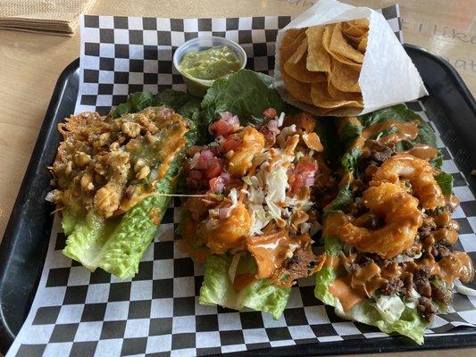 Tres romaine lettuce tacos, queso taco, surf & turf and the El Captain.