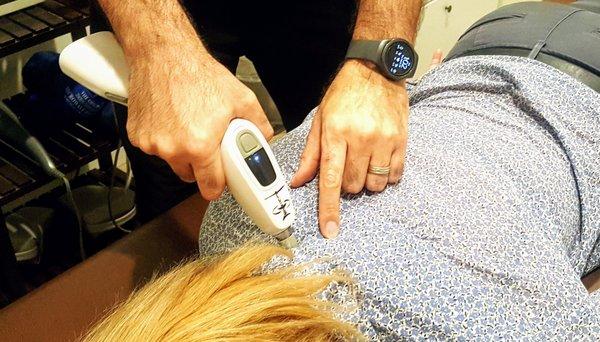 Torrance chiropractor is gently treating patients back and neck pain by using Activator tool.