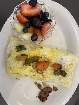 Veggie omelette with a cup of fruit