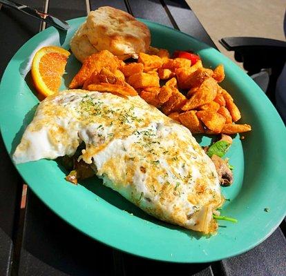 Egg white veggie omelette with potatoes and a biscuit.