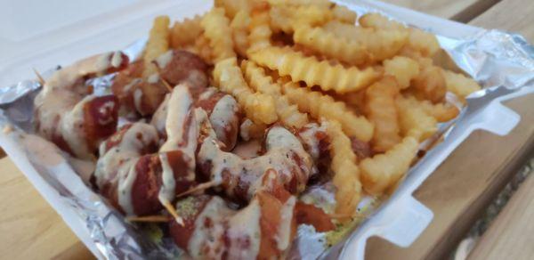 Bacon wrapped shrimp covered in 'Angel' sauce w/French fries.