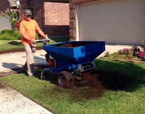 Spreading compost on lawn rejuvenates the soil .