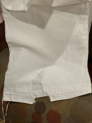 Large piece of linen pant torn away.