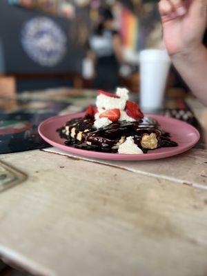 Pancake with chocolate , whip cream and strawberries on top