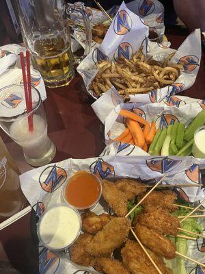 Chicken skewers, side of fries, side of carrots and celery