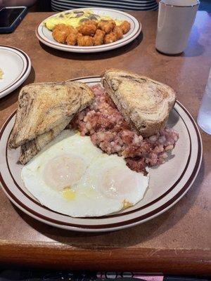 Corned beef hash and eggs with marbled rye toast. You can see my brother's Italian sausage omelette with tots in the background