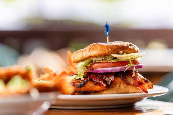 Salmon Club - 
fresh salmon filet, broiled, bacon, basil pesto mayo, lettuce, tomato, brioche