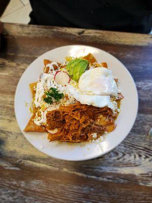 This is the chilaquiles is a tomatillo sauce with over medium eggs and pork, you get to choose your meats or even no meat