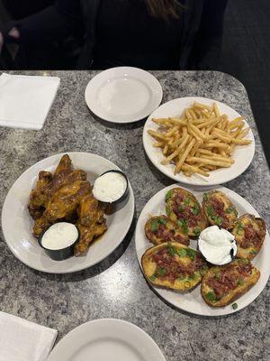 Trashed wings, fries and potato skins.