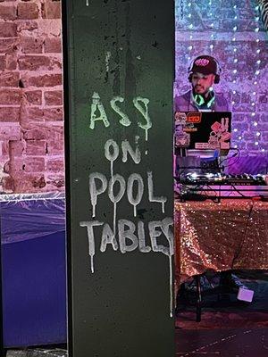 Dj and sign that's meant to read: no ass on pool tables