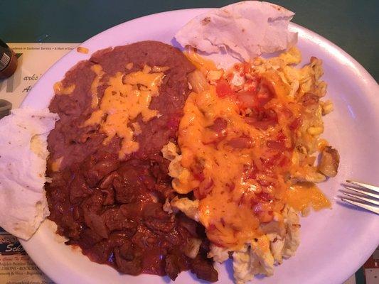 Left: refritos with cheese and delicioso guiso. Right: eggs and potatoes covered in Spanish sauce and cheese.