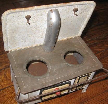 My rusty, dented old doll stove before being repaired by Dr. Toni's.  I thought I would have to throw it away.