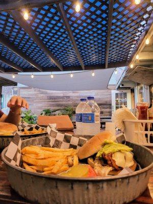 Chicken burger with avocado, american cheese and bacon. Served with freshly seasoned fries