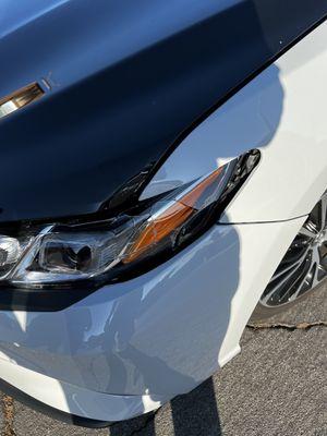 The damage to my hood, fender and left head lamp.