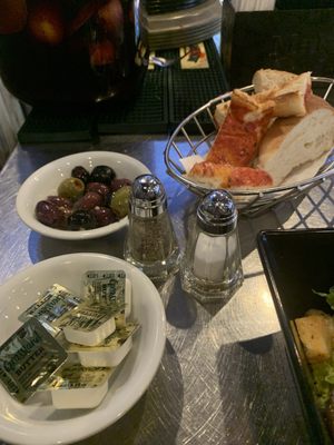 The bread and olives that come with a meal