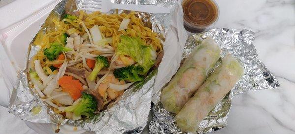 Stir fried egg noodles with beef, chicken, shrimp, and veggies  Shrimp spring rolls