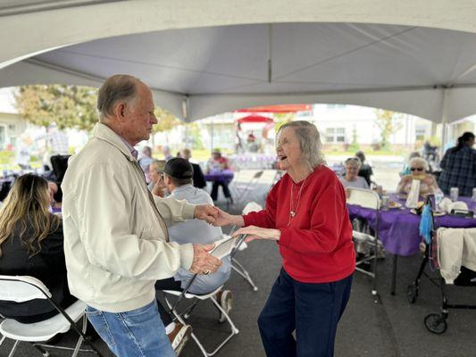 Enjoying live music, outdoor BBQ, and plenty of fun!