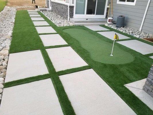 Large square pavers and artificial turf plus a small putting green in Denver.