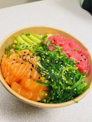 Tuna and salmon poke bowl with seaweed salad