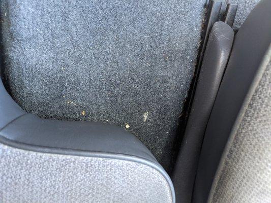 left over dirty carpet near car seat