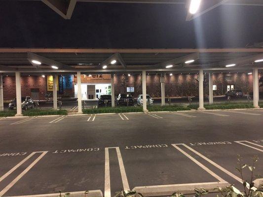 Parking lot (that I've never used) is covered by solar panels. The building's bright entrance ushers you into the incubator's hull.