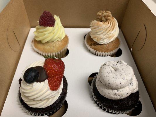 Lemon Raspberry Cupcake, Mixed Berry Ganache Cupcake, Cookies & Cream Cupcake, and Salted Pecan Cupcake.