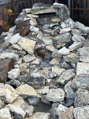 Pondless waterfall done stone by stone with a filtration system and pump