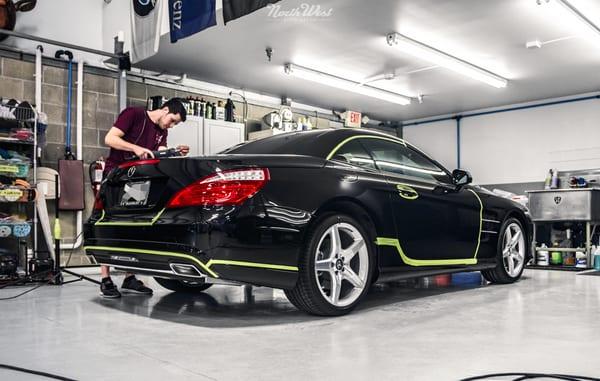 Reconditioning Specialist Ben works away on a Mercedes SL that's due for paint correction.