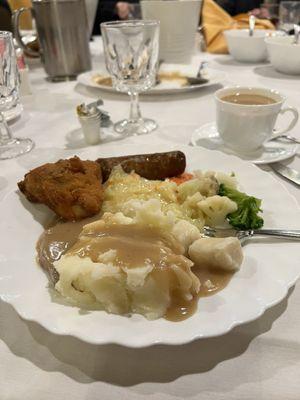 Food variety... fried chicken, mashed potatoes, fresh vegetables, Italian sausage, sauerkraut and dumplings.