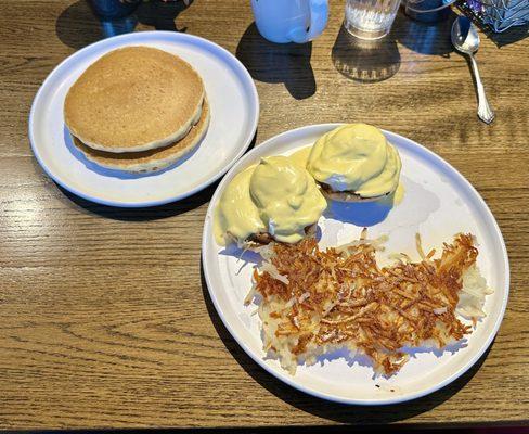 Eggs Benedict, hash browns, and a side of pancakes