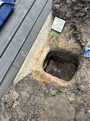 A "boxed" hole for perimeter beam access to install pilings under a slab foundation