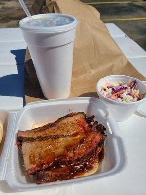 Sweet tea, brisket sandwich, and cole slaw.