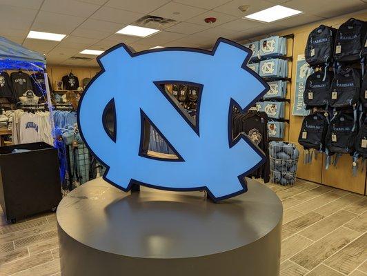 Large UNC logo inside UNC Student Stores lower level.