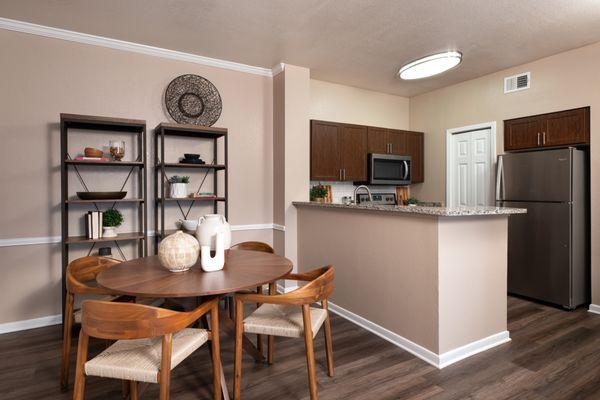 Dining room with view of kitchen at Crescent Cove at Lakepointe