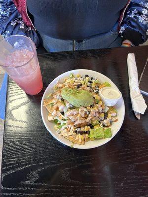 Loaded nachos with shrimp and guacamole and a sunset lemonade.