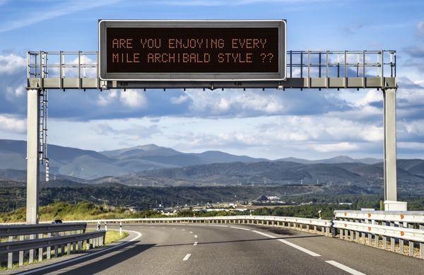 Highway sign about "Enjoying Every Mile Archibald Style"