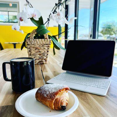 Oat milk latte and croissant