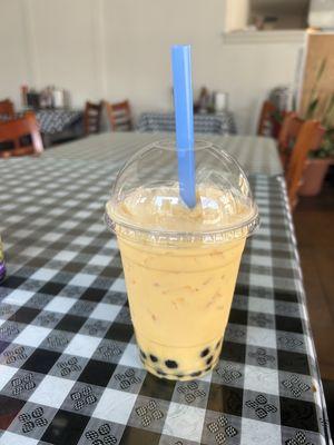 Mango milk tea with boba and lychee jelly.